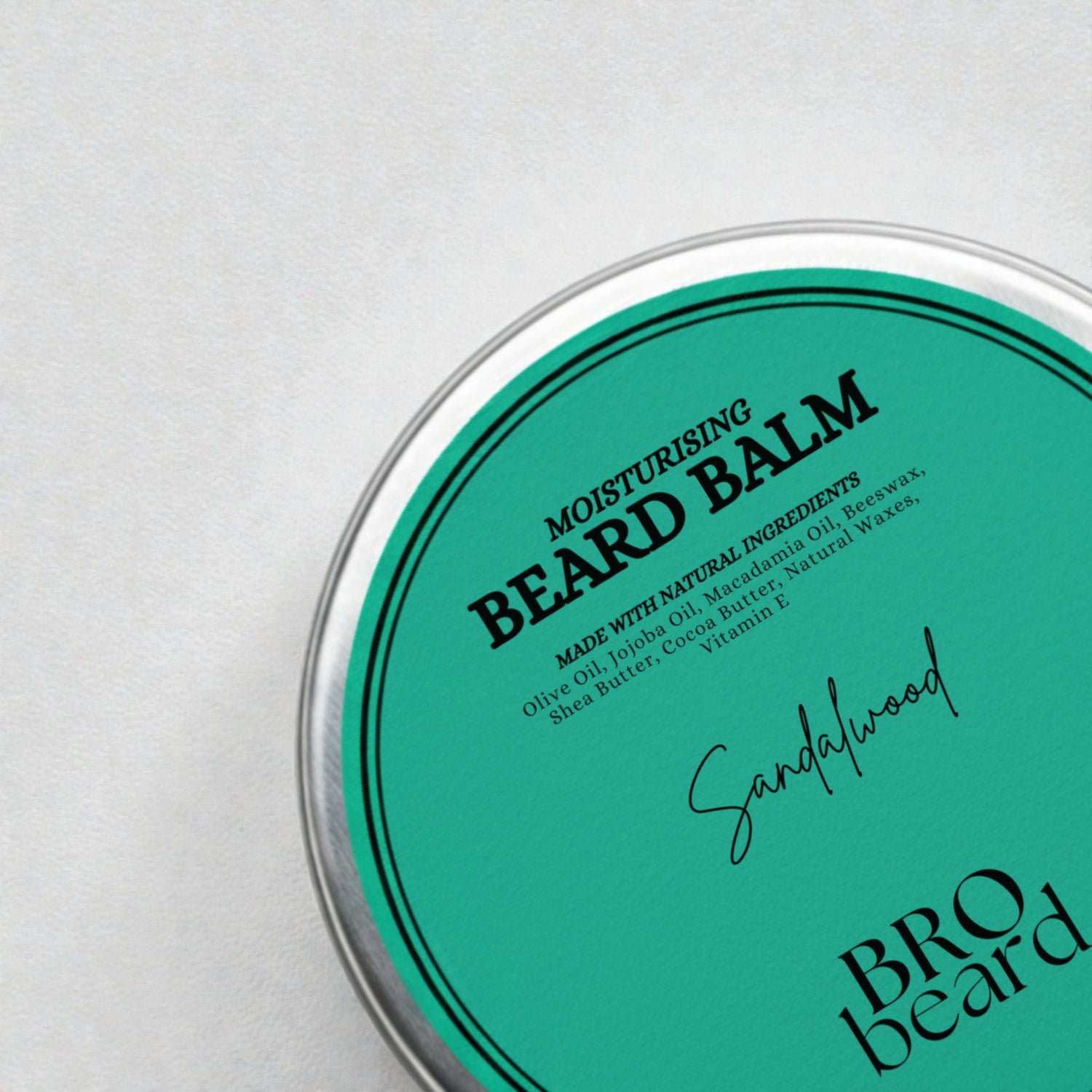 Moisturizing beard balm container with green lid and white base on a light gray background